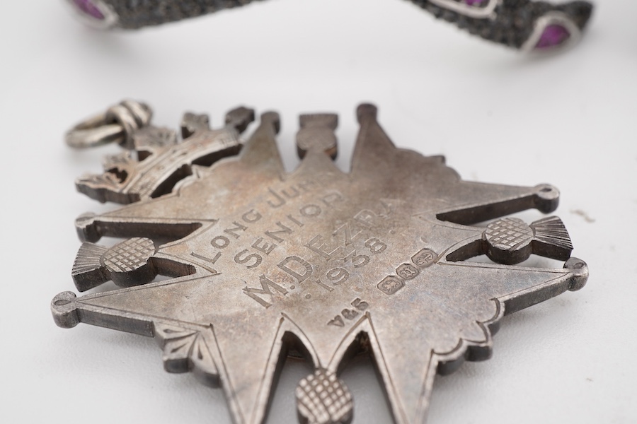 A collection of jewels including a snake bracelet, comprising: a hinged bangle modelled as a snake in silver, pavé-set with circular-cut black sapphires and synthetic rubies, its tongue a marquise-shaped synthetic ruby,